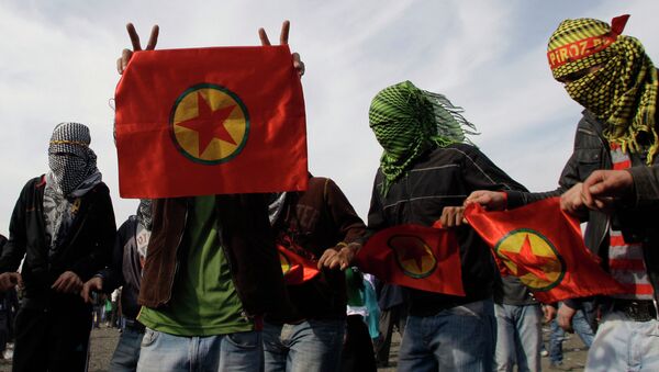 Masked men display flags of outlawed rebel group of the PKK, as Turkish Kurds celebrate the Nowruz in Istanbul, Turkey, Sunday, March 21, 2010. File photo - Sputnik International