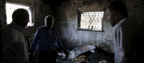 Palestinians inspect a house which was set on fire in a suspected attack by Jewish extremists in Duma village near the West Bank city of Nablus Palestinians inspect a house which was set on fire in a suspected attack by Jewish extremists in Duma village near the West Bank city of Nablus - Sputnik International