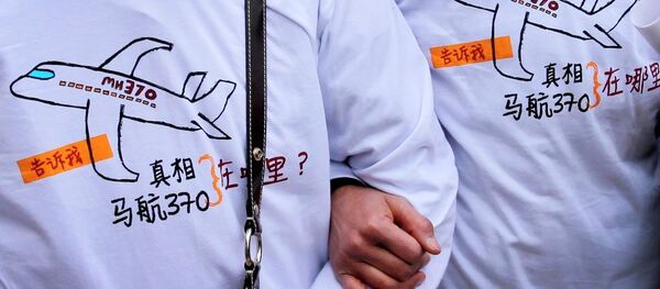 Relatives of passengers on board the Malaysia Airlines Flight 370 that went missing on March 8, 2014, wearing T-shirts carrying a message for the missing flight as they leave Yonghegong Lama Temple after a gathering of family members of the missing passengers, in Beijing Sunday, March 8, 2015. Relatives of passengers on board the Malaysia Airlines Flight 370 that went missing on March 8, 2014, wearing T-shirts carrying a message for the missing flight as they leave Yonghegong Lama Temple after a gathering of family members of the missing passengers, in Beijing Sunday, March 8, 2015. - Sputnik International