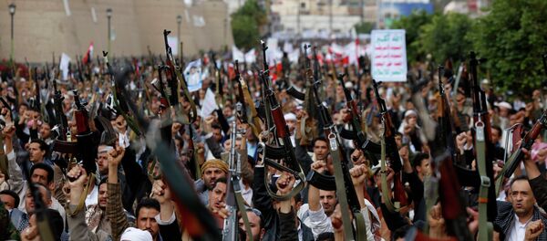 Shiite rebels known as Houthis hold up their weapons as they chant slogans during a rally against Saudi-led airstrikes in Sanaa, Yemen. Shiite rebels known as Houthis hold up their weapons as they chant slogans during a rally against Saudi-led airstrikes in Sanaa, Yemen. - Sputnik International