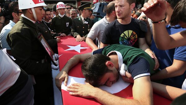 A relative cries over the Turkish flag-draped coffin of Turkish soldier Kagan Kandemir, during his funeral in the town of Civril, Turkey, July 31, 2015 - Sputnik International