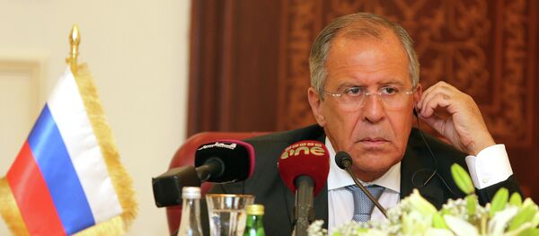 Russia's Foreign Minister Sergey Lavrov listens during a joint press conference with Qatari Foreign Minister Khalid bin Mohammad Al-Attiyah (unseen) on August 3, 2015 in Doha - Sputnik International