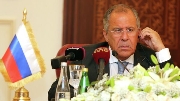 Russia's Foreign Minister Sergey Lavrov listens during a joint press conference with Qatari Foreign Minister Khalid bin Mohammad Al-Attiyah (unseen) on August 3, 2015 in Doha - Sputnik International