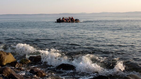 Migrants from Syria and Afghanistan arrive on an overcrowded dinghy from the Turkish coasts to the Greek island of Lesbos, Monday, July 27, 2015 - Sputnik International