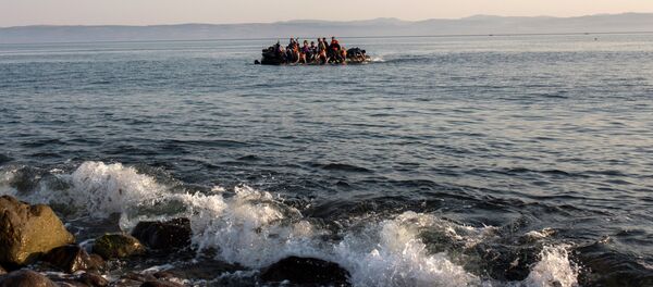 Migrants from Syria and Afghanistan arrive on an overcrowded dinghy from the Turkish coasts to the Greek island of Lesbos, Monday, July 27, 2015 Migrants from Syria and Afghanistan arrive on an overcrowded dinghy from the Turkish coasts to the Greek island of Lesbos, Monday, July 27, 2015 - Sputnik International