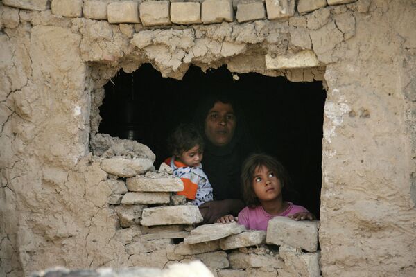 Iraqi family stands inside their home hit by an airstrike in Fidhailiya area in eastern Baghdad, Iraq. Iraqi family stands inside their home hit by an airstrike in Fidhailiya area in eastern Baghdad, Iraq. - Sputnik International