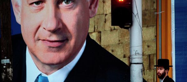 An Israeli ultra-orthodox Jewish man walks past an election campaign billboard of Israeli Prime Minister and Likud Party leader Benjamin Netanyahu, in Bnei Brak, near Tel Aviv, Israel, Sunday, Jan. 6, 2013. - Sputnik International