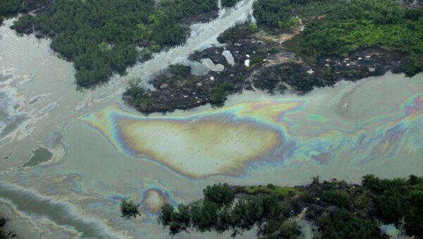 Oil is seen on the creek water's surface near an illegal oil refinery in Ogoniland, outside Port Harcourt. File photo - Sputnik International