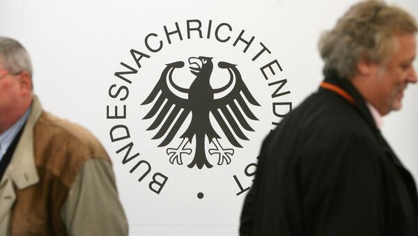 Guests walk past a logo of Germany's intelligence agency the Bundesnachrichtendienst (BND - Federal Intelligence Service) during a ground breaking ceremony for the new national headquarters of the BND in Berlin's Mitte district - Sputnik International