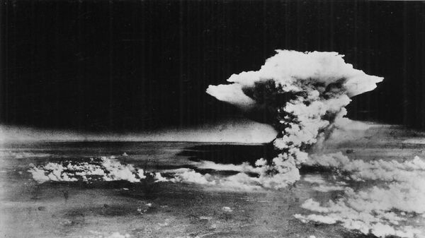 An atomic cloud billows above Hiroshima city following the explosion of the first atomic bomb to be used in warfare in Hiroshima, in this handout photo taken by the U.S. Army on August 6, 1945, and distributed by the Hiroshima Peace Memorial Museum. The words written on the photo are from the source - Sputnik International
