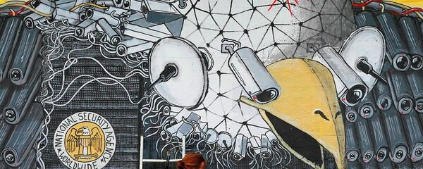 Artist A. Signl, of the artist group Captain Borderline paints the mural 'Surveillance of the fittest' at a wall in Cologne, Germany, Thursday, Oct. 24, 2013. Artist A. Signl, of the artist group Captain Borderline paints the mural 'Surveillance of the fittest' at a wall in Cologne, Germany, Thursday, Oct. 24, 2013. - Sputnik International