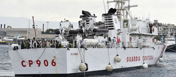 Migrants wait to disembark from Italian Coast Guard ship Oreste Corsi, at the Messina harbor in Sicily, Italy, Tuesday, Aug. 4, 2015 - Sputnik International