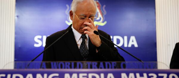 Malaysian Prime Minister Najib Razak, center, gestures before speaking at a special press conference announcing the findings for the ill fated flight MH370 in Kuala Lumpur, Malaysia, early Thursday, Aug. 6, 2015 Malaysian Prime Minister Najib Razak, center, gestures before speaking at a special press conference announcing the findings for the ill fated flight MH370 in Kuala Lumpur, Malaysia, early Thursday, Aug. 6, 2015 - Sputnik International