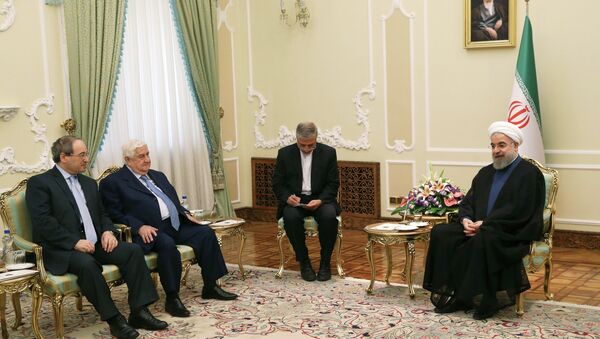 Iranian President Hassan Rouhani, from right, speaks with Syrian Foreign Minister Walid al-Moallem as Syrian Deputy Foreign Minister Faisal Mekdad listens during their meeting at the presidency office in Tehran, Iran, Wednesday, Aug. 5, 2015. - Sputnik International