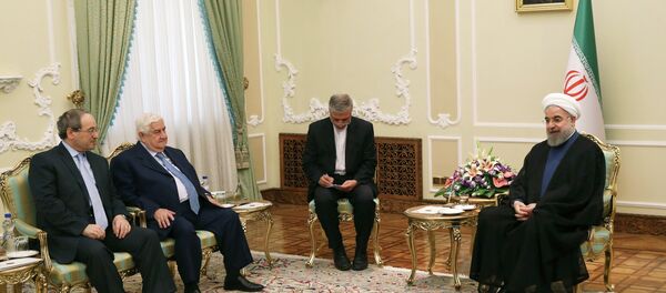 Iranian President Hassan Rouhani, from right, speaks with Syrian Foreign Minister Walid al-Moallem as Syrian Deputy Foreign Minister Faisal Mekdad listens during their meeting at the presidency office in Tehran, Iran, Wednesday, Aug. 5, 2015. Iranian President Hassan Rouhani, from right, speaks with Syrian Foreign Minister Walid al-Moallem as Syrian Deputy Foreign Minister Faisal Mekdad listens during their meeting at the presidency office in Tehran, Iran, Wednesday, Aug. 5, 2015. - Sputnik International