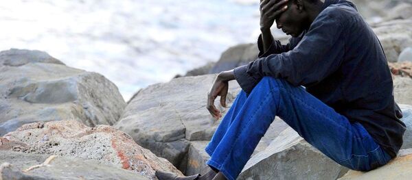 A migrant sits on rocks by the sea in Ventimiglia, at the Italian-French border, Tuesday, June 16, 2015. A migrant sits on rocks by the sea in Ventimiglia, at the Italian-French border, Tuesday, June 16, 2015. - Sputnik International