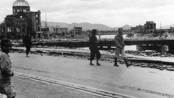 Local residents walk past the gutted Hiroshima Prefectural Industrial Promotion Hall - Sputnik International