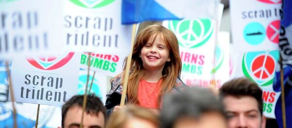 Protesters hold placards against nuclear weapons during a rally against the Trident nuclear program in the center of Glasgow, Scotland, on April 4, 2015. - Sputnik International
