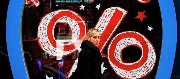 A woman walks past a shop offering discounts in downtown Lisbon, Thursday, Jan. 9, 2014. A woman walks past a shop offering discounts in downtown Lisbon, Thursday, Jan. 9, 2014. - Sputnik International