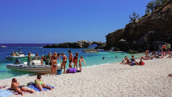 Tourists sunbathing at the beach of Cala Luna, Gulf of Orosei, Sardinia, Italy. - Sputnik International