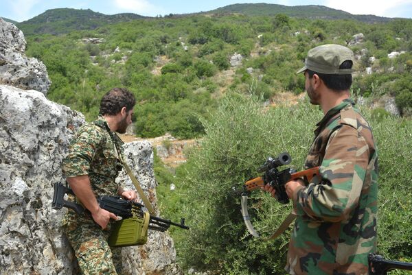 Syrian pro-government forces patrol an area in the Sahl al-Ghab, in Hama province, on June 7, 2015 - Sputnik International