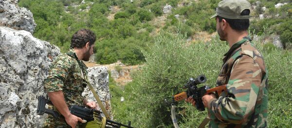 Syrian pro-government forces patrol an area in the Sahl al-Ghab, in Hama province, on June 7, 2015 - Sputnik International