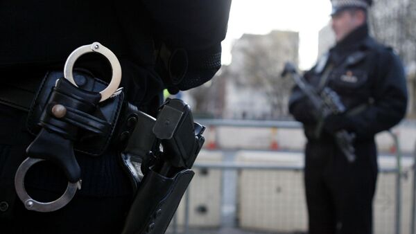Armed policemen stand guard in Grosvenor Square in London. File photo - Sputnik International