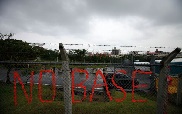 A slogan against the base is displayed on the fence enclosed U.S. Marine Corps Futenma Air Station in Ginowan on southern Japanese islands of Okinawa. File photo - Sputnik International