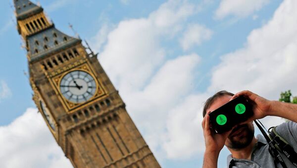 A man looks through a virtual reality device that shows a 360 degree view of the city of Aleppo, Syria during an Amnesty International protest in Parliament Square to urge the British government to do more to help Syrian refugees, London, Saturday, July 11, 2015. - Sputnik International