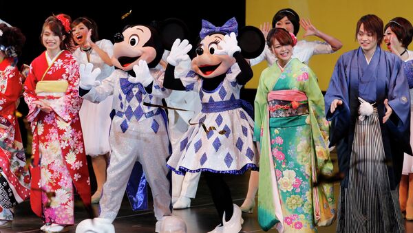 People celebrate with Disney characters on stage during a ceremony at Tokyo Disneyland. - Sputnik International