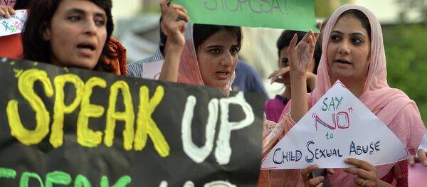 Pakistani rights activists carry placards as they shout slogans during a protest against a child sex abuse scandal in Islamabad on August 10, 2015 Pakistani rights activists carry placards as they shout slogans during a protest against a child sex abuse scandal in Islamabad on August 10, 2015 - Sputnik International