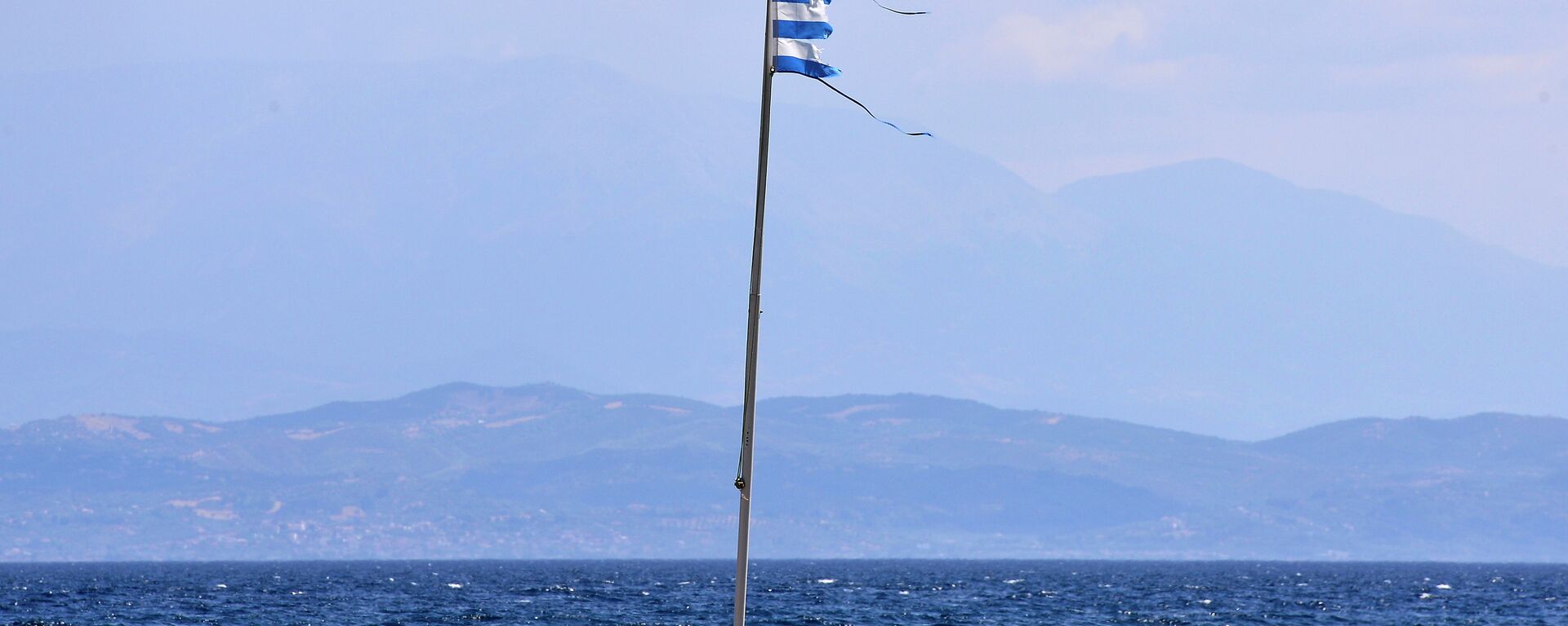 A torn Greek flag flutters at a coast near Antirio, southwest of Athens on August 9, 2015 - Sputnik International, 1920, 08.06.2024