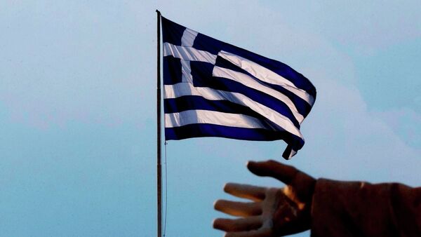A hand of a statue is seen as the Greek flag waves in Athens, Sunday, June 28, 2015. - Sputnik International