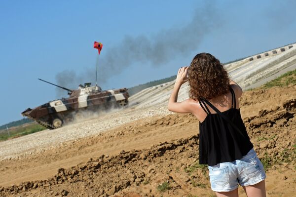 A spectator takes photos of an infantry combat vehicle of Venezuela's team during the Suvorov Onslaught competition of BMP-2 IFVs as part of the International Army Games 2015. The venue was held at the Alabino training field outside Moscow. A spectator takes photos of an infantry combat vehicle of Venezuela's team during the Suvorov Onslaught competition of BMP-2 IFVs as part of the International Army Games 2015. The venue was held at the Alabino training field outside Moscow. - Sputnik International