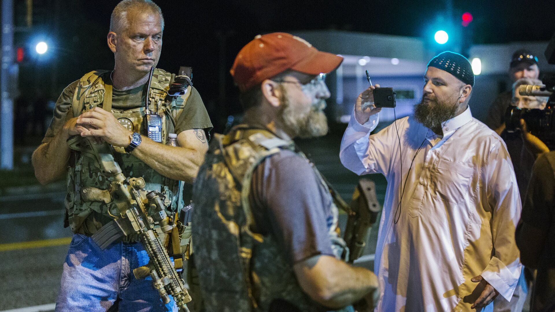 Members of the Oath Keepers walk with their personal weapons on the street during protests in Ferguson, Missouri August 11, 2015. - Sputnik International, 1920, 23.01.2022