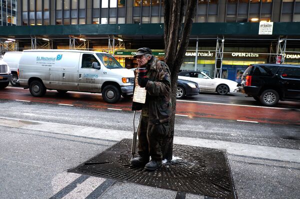 A homeless man begs for donations outside a subway station in New York on February 4, 2015 A homeless man begs for donations outside a subway station in New York on February 4, 2015 - Sputnik International