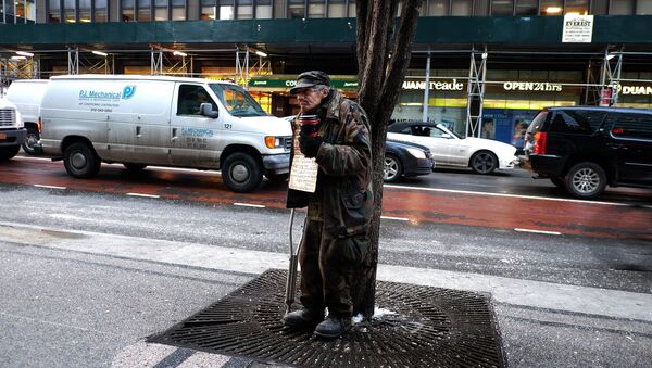 A homeless man begs for donations outside a subway station in New York on February 4, 2015 - Sputnik International