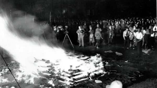 Flames roar high as a crowd gathers to witness thousands of books, considered to be un-German, burn in Opera Square in Berlin, Germany, during the Buecherverbrennung, book burnings on May 10, 1933. - Sputnik International
