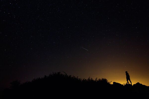 A Perseid meteor along the Milky Way illuminates the dark sky near Villadiego in the province of Burgos, northern Spain, during the Perseids meteor shower on August 12, 2015 A Perseid meteor along the Milky Way illuminates the dark sky near Villadiego in the province of Burgos, northern Spain, during the Perseids meteor shower on August 12, 2015 - Sputnik International