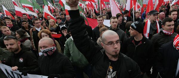 Right wing protesters wave flags at the start of the Independence Day march organized by nationalist parties, in Warsaw, Poland, Tuesday, Nov. 11, 2014 - Sputnik International