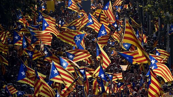 A file picture taken on September 11, 2014 shows demonstrators waving Estelada flags (Catalan independentist flags) during celebrations of the Diada (Catalonia National Day) in Barcelona. - Sputnik International