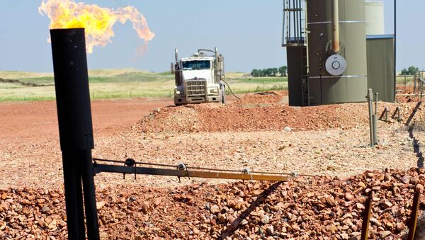 Photo taken August 19, 2013 shows natural gas burning off at an oil well site near Tioga, North Dakota - Sputnik International
