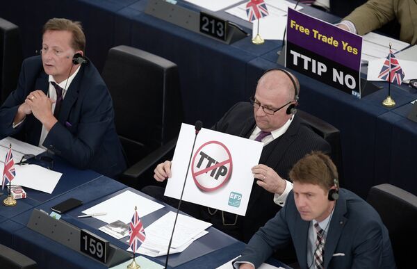Members of the European Parliament take part in a voting session as they hold signs against the Transatlantic Trade and Investment Partnership (TTIP), on June 10, 2015, in the European Parliament in Strasbourg, eastern France - Sputnik International