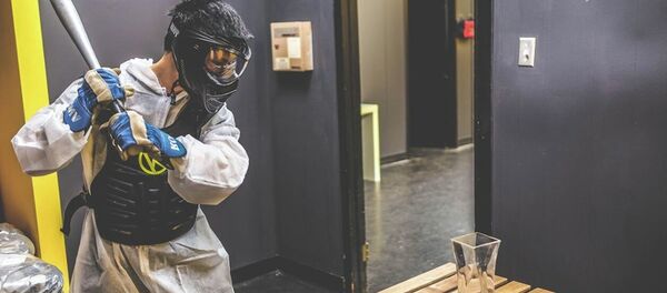 A customer prepares to swing a baseball bat at a vase in the Rage Room at Battle Sports in Toronto, Canada. - Sputnik International