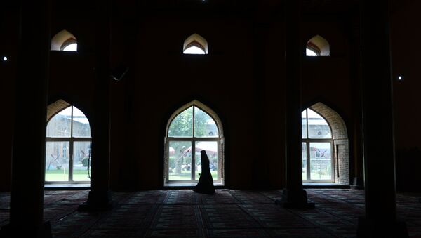 A Kashmiri Muslim woman walks after praying inside the grand mosque Jamia Masjid during Ramadan in downtown Srinagar on June 25, 2015. File photo - Sputnik International