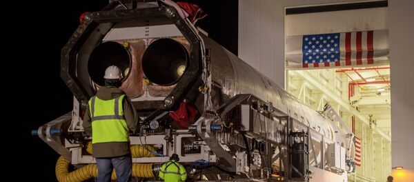An Orbital Science Corporation Antares rocket is seen as it is rolled out to launch Pad-0A at NASA's Wallops Flight Facility Tuesday, December 17, 2013 in advance of a Thursday launch, Wallops Island, VA. - Sputnik International