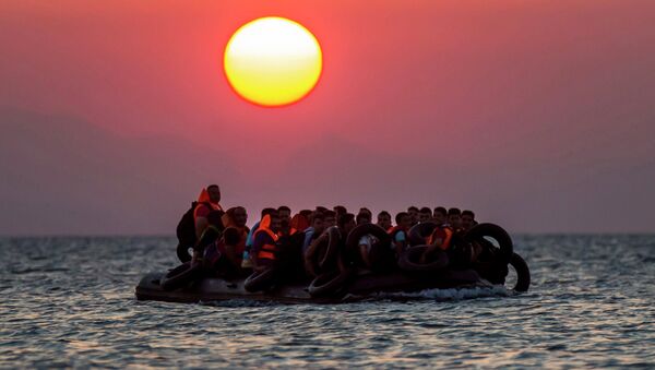 Migrants on a dinghy arrives at the southeastern island of Kos, Greece, after crossing from Turkey, Thursday, Aug. 13, 2015 - Sputnik International
