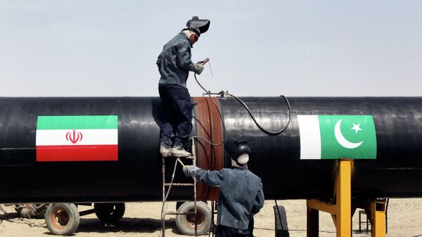 In this March 11, 2013 file photo, Iranian workers weld two gas pipes together at the start of construction on a pipeline to transfer natural gas from Iran to Pakistan, in Chabahar, southeastern Iran, near the Pakistani border. File photo - Sputnik International