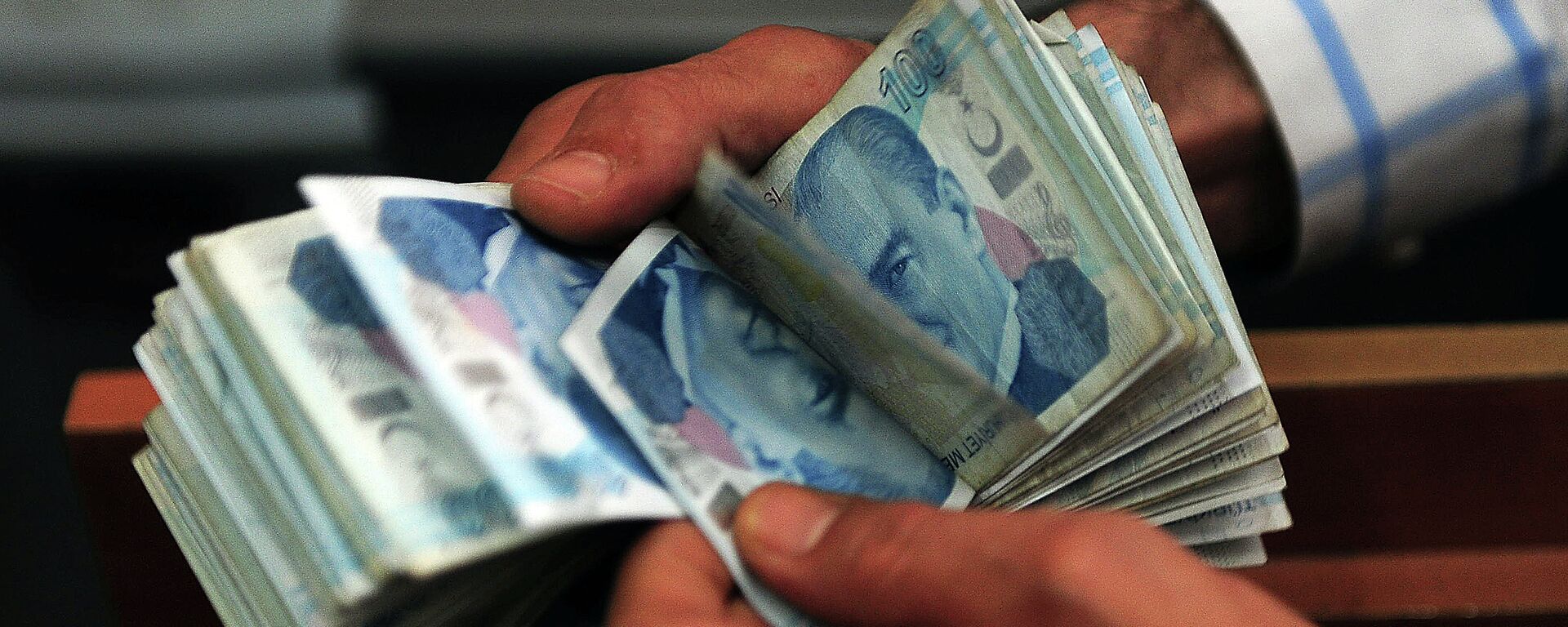 An exchange office worker counts Turkish lira banknotes in Istanbul on June 8, 2015 - Sputnik International, 1920, 30.05.2023