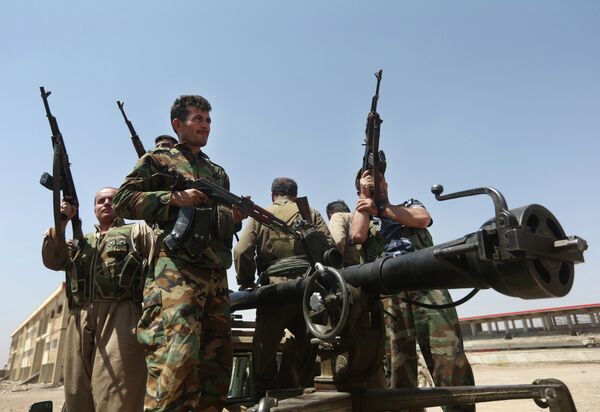 In this Wednesday, June 25, 2014 file photo, Kurdish peshmerga fighters take positions on the front line with militants from the al-Qaida-inspired Islamic State in Iraq and the Levant, in Tuz Khormato, 100 kilometers (62 miles) south of Kirkuk, northern Iraq In this Wednesday, June 25, 2014 file photo, Kurdish peshmerga fighters take positions on the front line with militants from the al-Qaida-inspired Islamic State in Iraq and the Levant, in Tuz Khormato, 100 kilometers (62 miles) south of Kirkuk, northern Iraq - Sputnik International